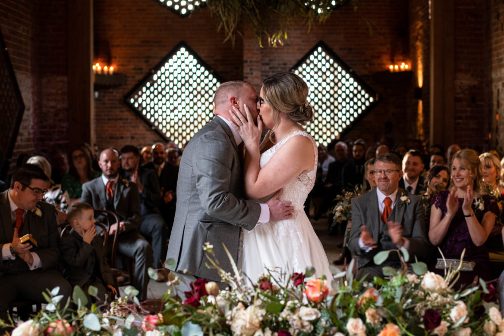 bride and groom first kiss. Shustoke Barn. Cripps & Co